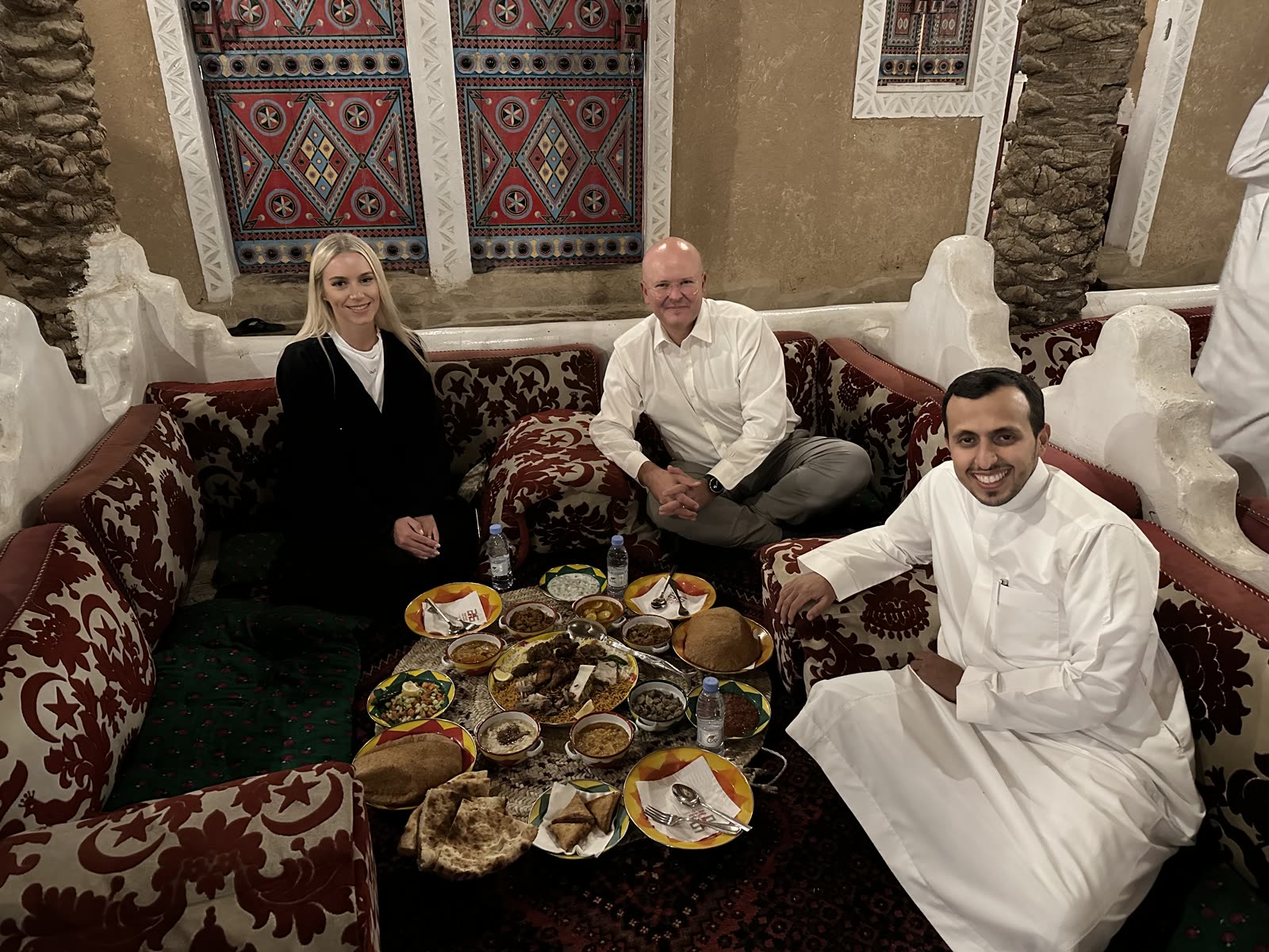Robert Hausmann sharing a traditional meal and conversation with colleagues in the Gulf.