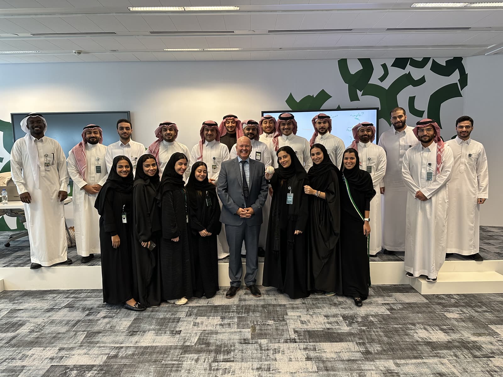 Robert Hausmann with a leadership cohort gathered in a Riyadh office.