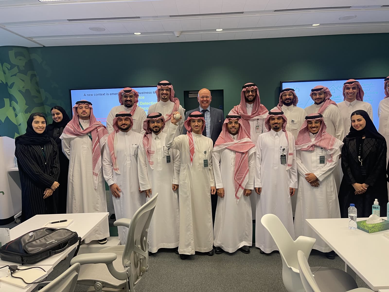 A leadership workshop cohort gathered around Robert Hausmann in Saudi Arabia.